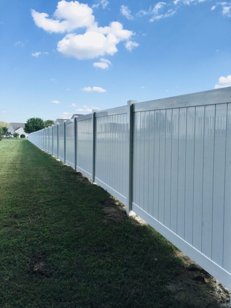 tall white fence with grassBNB Fence, Inc.